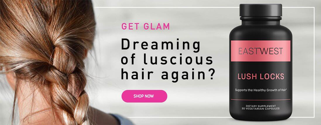 A woman with long hair examines a bottle of hair loss treatment, appearing contemplative about her hair care options.