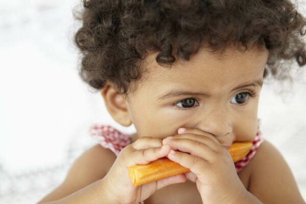 Young Girl Eating Carrot Stick