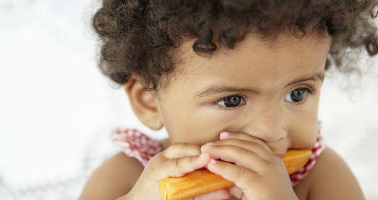 Young Girl Eating Carrot Stick