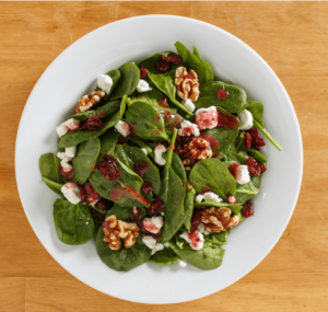 Spinach salad with toasted walnuts and goat cheese