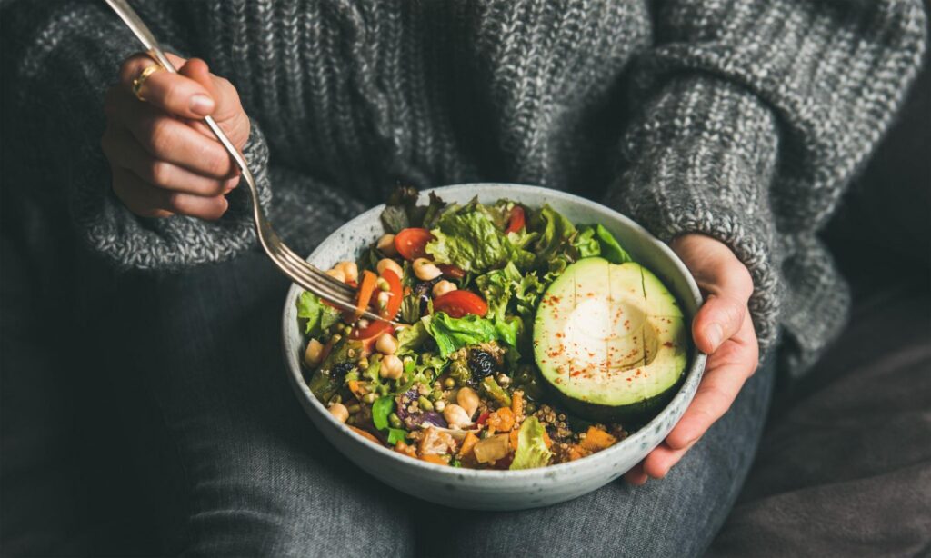 A woman eating a healthy salad