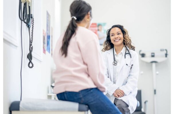 A female doctor discusses BRCA1 test results with a patient, providing guidance on navigating life after a positive diagnosis.
