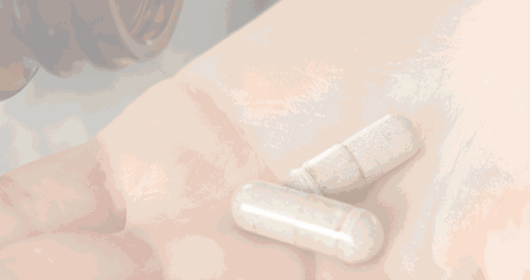 A person holding a pill in their hand, representing HolBody's focus on health and wellness.