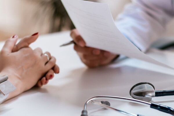 A doctor holds a stethoscope and a paper, representing ADHD clinic options in Atlanta.