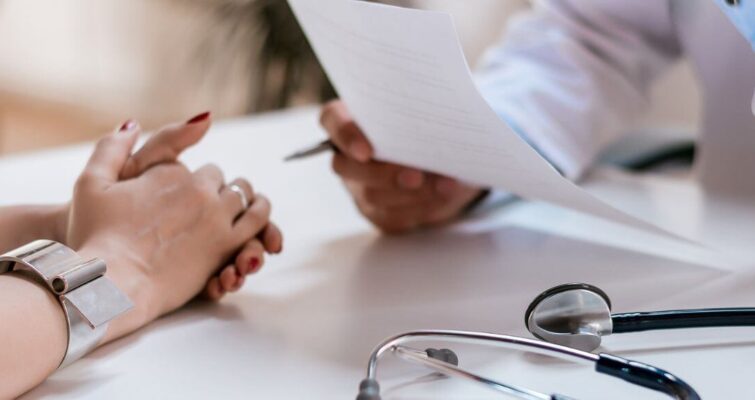 A doctor holds a stethoscope and a paper, representing ADHD clinic options in Atlanta.