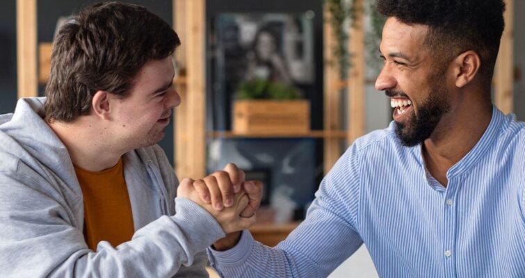 Two men shaking hands in an office, symbolizing collaboration in autism testing resources in Atlanta.