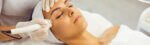 A woman receiving a facial treatment at a spa, focusing on skin care and relaxation.