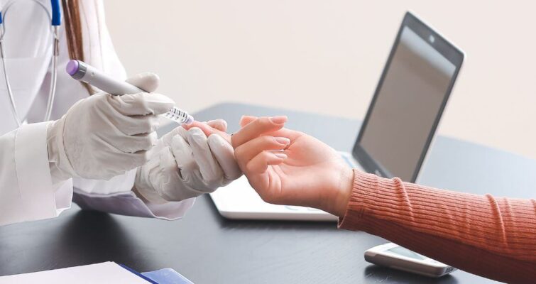 A doctor offers a supportive hand to a patient in a diabetes clinic, emphasizing compassionate care in Atlanta.