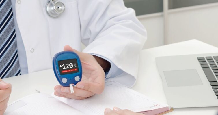 A doctor holds a blood glucose meter, emphasizing diabetes management in Atlanta's healthcare landscape.