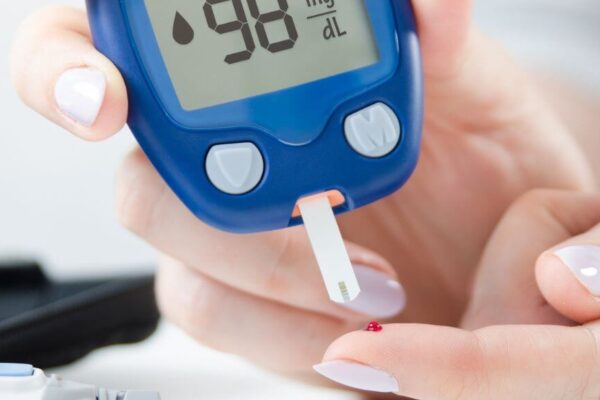 A person holds a digital blood sugar meter, emphasizing diabetes testing options in Atlanta's reliable centers.