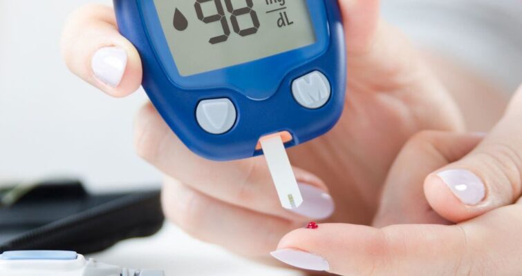 A person holds a digital blood sugar meter, emphasizing diabetes testing options in Atlanta's reliable centers.