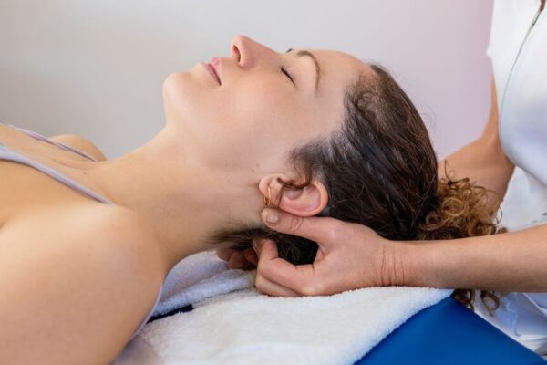 A woman receiving a massage in a serene room at Holistic Health Options in Atlanta.