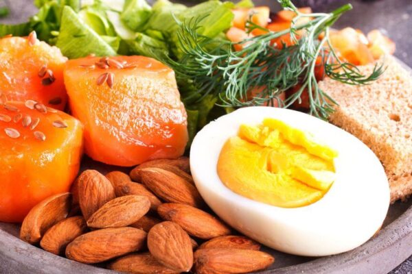 A bowl of hormone-balancing food featuring eggs, carrots, and various nutritious ingredients.