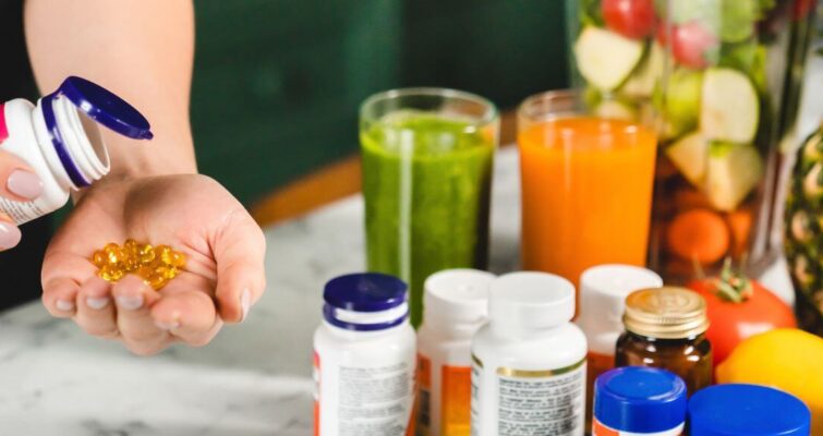 A woman holds a bottle of hormone balancing vitamins alongside other wellness items from a guide on supplements.