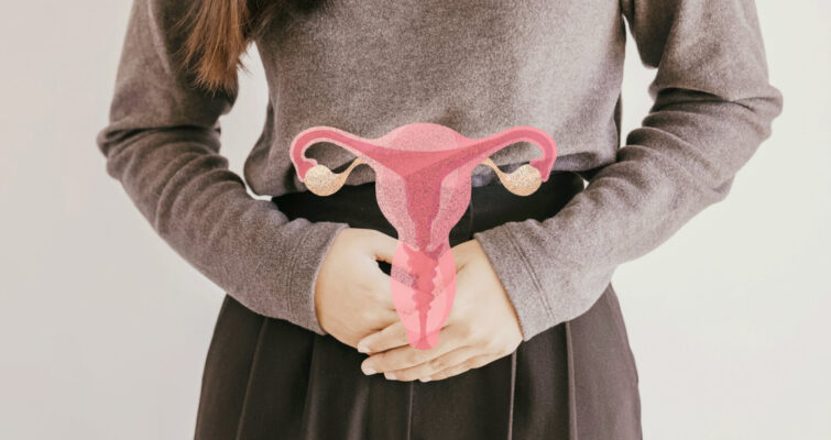 A woman holds her stomach, with a pink uterus graphic, symbolizing awareness of PCOS types.