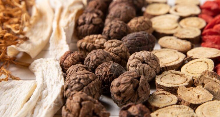 Chinese herbs and dried herbs arranged artistically, highlighting their significance in traditional Chinese medicine practices.