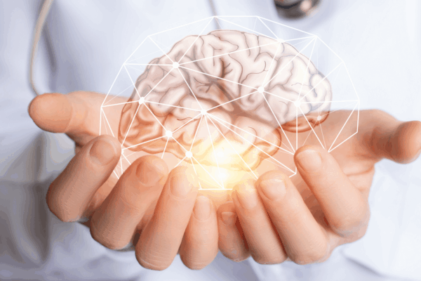 A doctor holds a human brain, symbolizing research on gut health's link to Alzheimer's and neurodegenerative diseases.