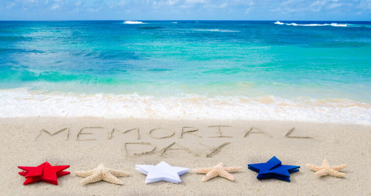 Memorial Day written in sand, accompanied by a starfish, promoting sun safety and skin cancer awareness.