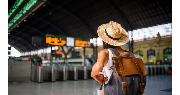 A traveler with a backpack walking on a trail, symbolizing tips for comfortable travel and avoiding digestive issues.