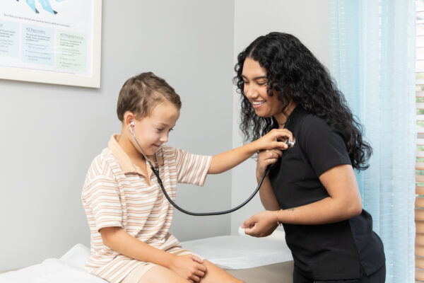 little boy listens to hear of a functional medicine provider during pediatric exam visit