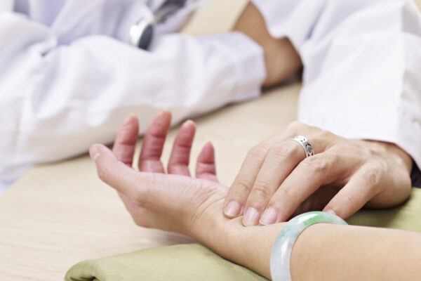 chinese medicine doctor taking pulse