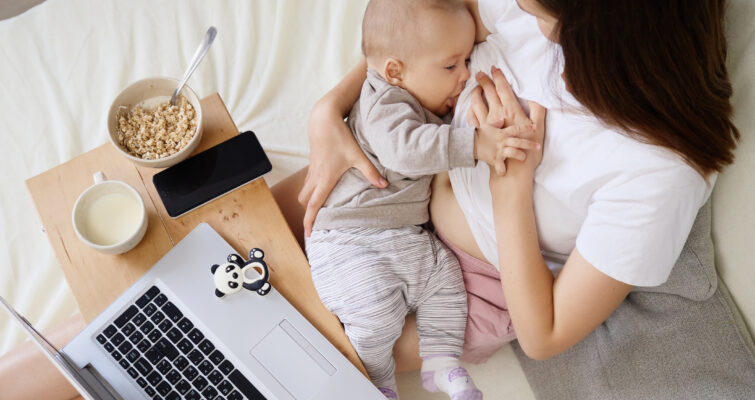 breastfeeding mother reading about functional medicine's approach to breastfeeding support