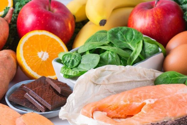 A colorful assortment of healthy foods: fruits, vegetables, eggs, milk, and meat for a hormone-balancing diet plan.