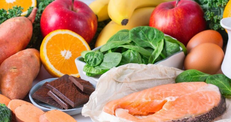 A colorful assortment of healthy foods: fruits, vegetables, eggs, milk, and meat for a hormone-balancing diet plan.