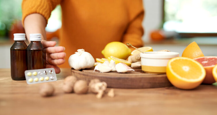 A woman holds a bottle of essential oils, highlighting natural remedies like quercetin and other antihistamines.