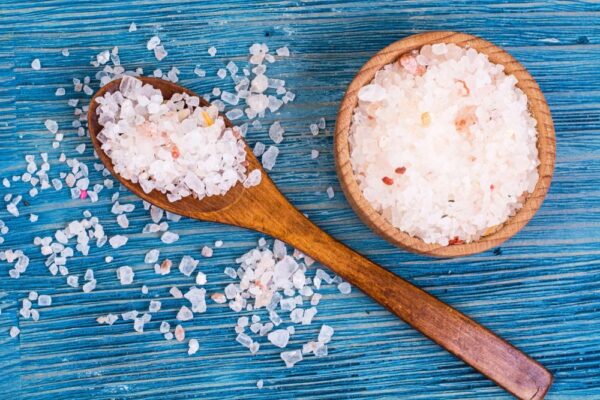 Himalayan salt lamp highlighting its skin benefits, surrounded by natural elements for a calming aesthetic.