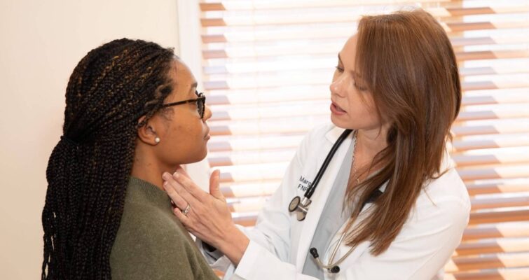 A woman receives a health examination from a functional medicine doctor, highlighting essential health checks for women's health