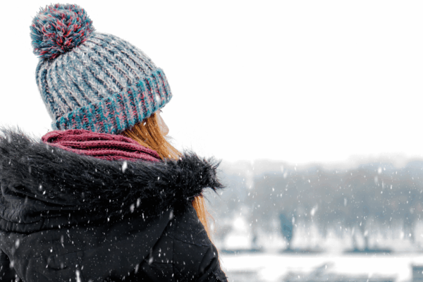A woman in winter experiencing symptoms of seasonal depression.
