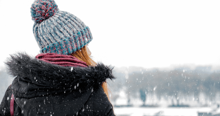 A woman in winter experiencing symptoms of seasonal depression.