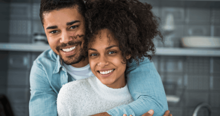 Smiling couple embracing, symbolizing health and vitality.