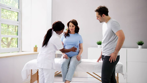 A woman receives a fertility exam from a doctor, focusing on natural conception methods without IVF.