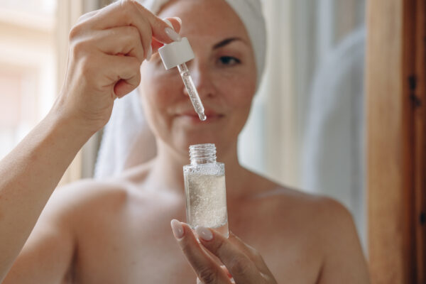 woman with a bottle of peptides for peptide therapy
