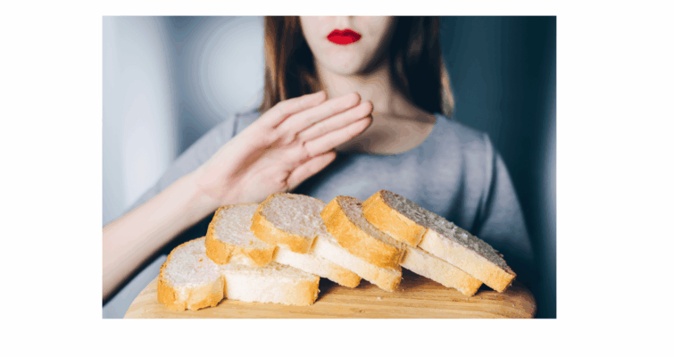 A woman holds a piece of bread in her hand, contemplating the link between allergies and autoimmune disease.