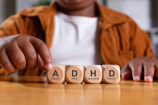 kid with Attention Deficit Hyperactive Disorder touching blocks that spell ADHD