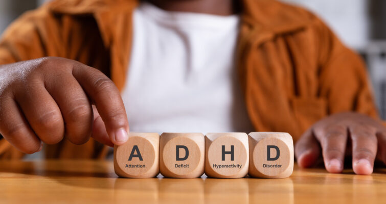 kid with Attention Deficit Hyperactive Disorder touching blocks that spell ADHD
