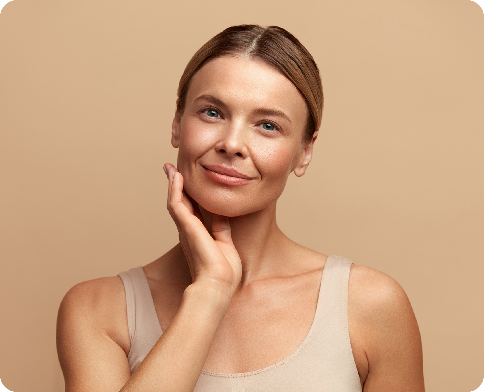 Woman with hand on her cheek, smiling.