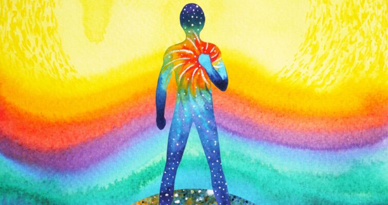 Colorful watercolor silhouette holding a glowing heart against a radiant, rainbow-hued background.