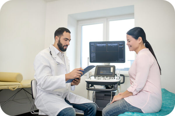 holistic doctor going over female patient results in exam room