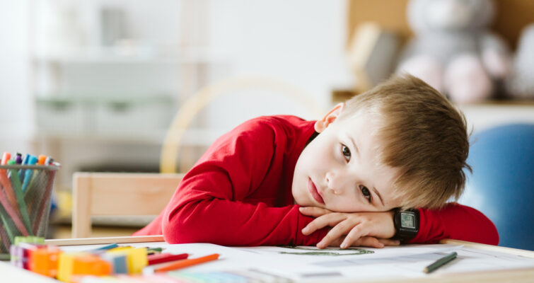 Exhausted child laying his head on a desk