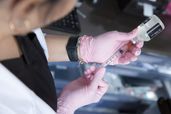Doctor holding peptide injection