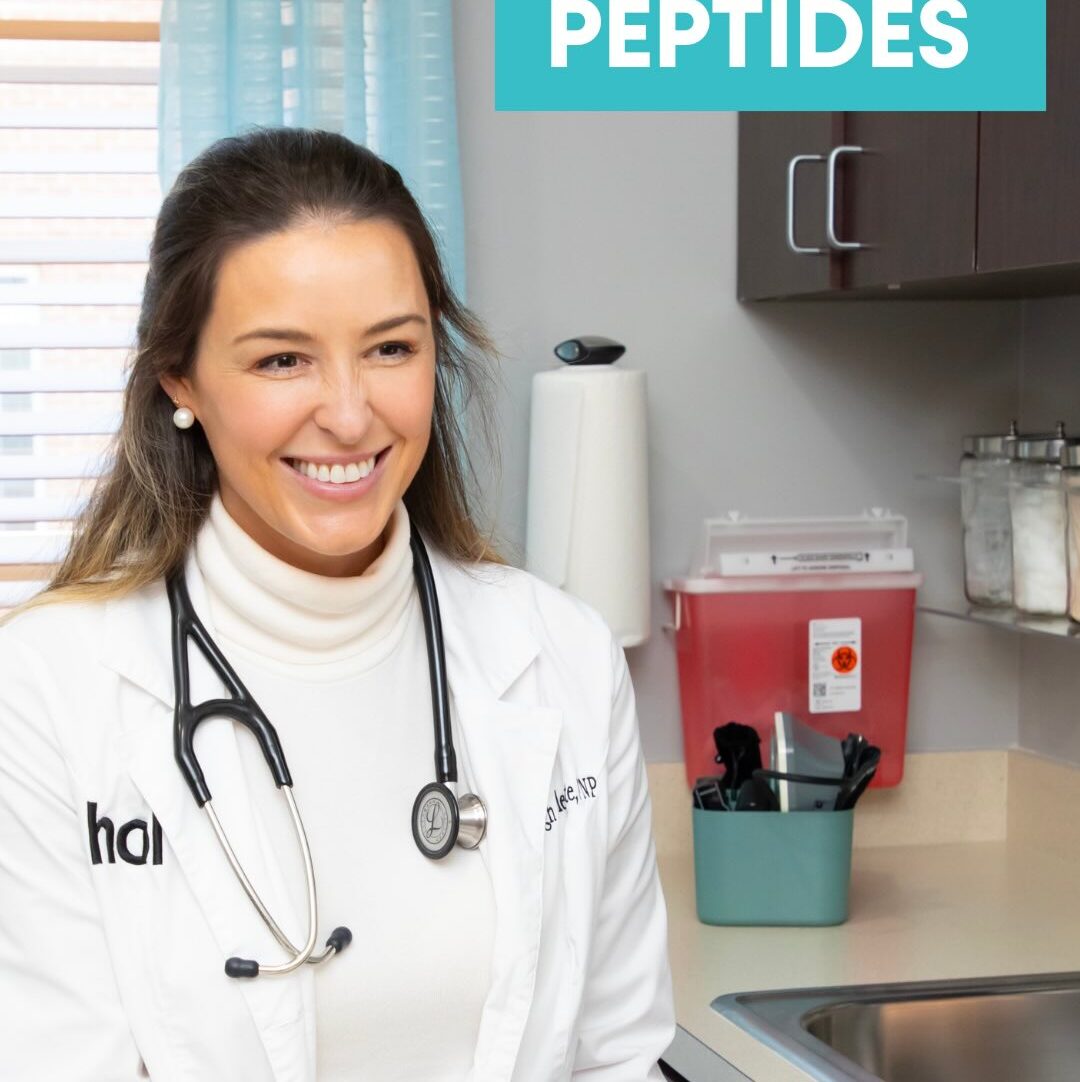 A healthcare professional in a white coat sits at a counter, smiling while holding a black supplement bottle in a brightly lit room.