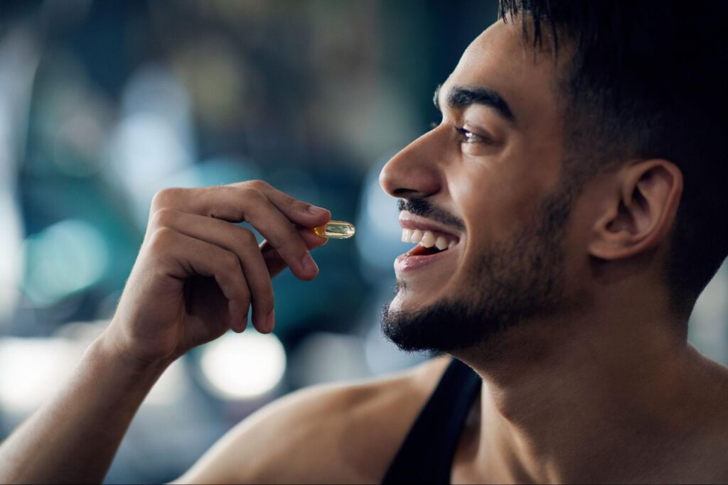 A smiling man taking a supplement for stress and anxiety