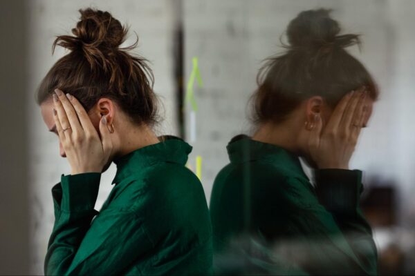 A woman clutching her head in stress