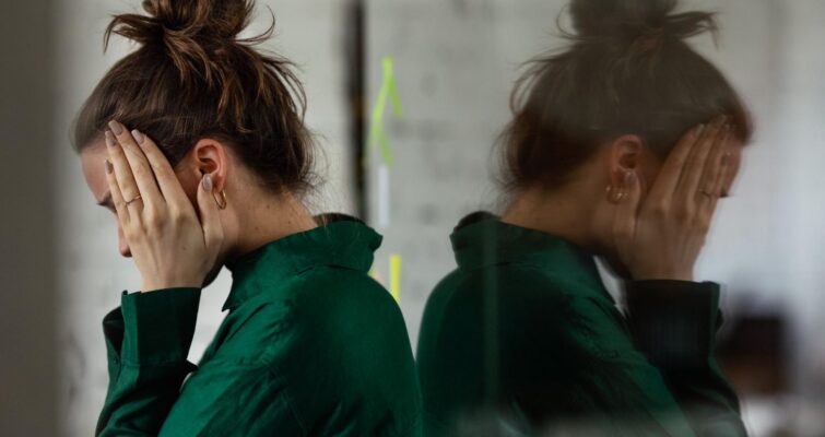 A woman clutching her head in stress