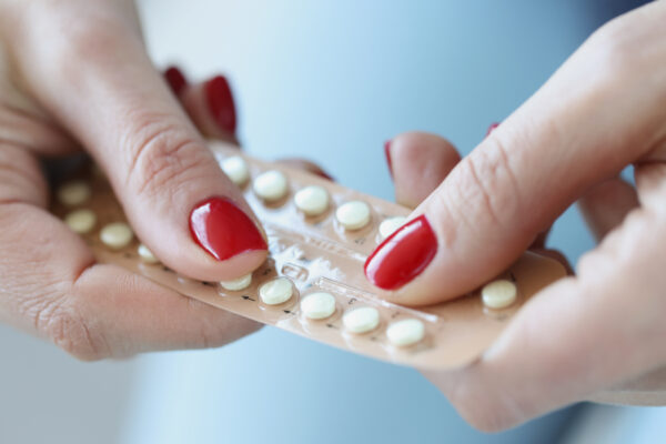 Woman holding progesterone pills