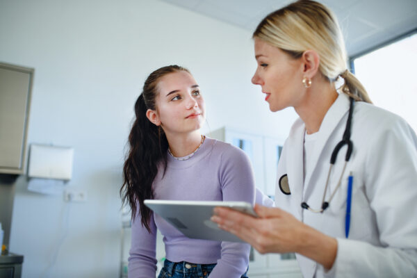 Doctor explaining diagnosis to teenage girl